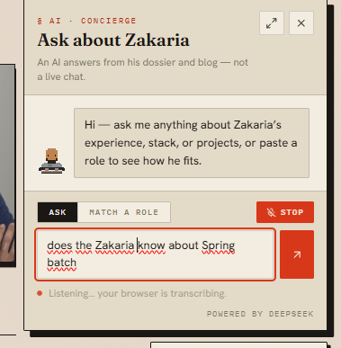 The same panel a moment later: the settled phrase “does the Zakaria know about Spring batch” now sits in the composer with the browser’s spell-check underlining it, while the microphone is still running.